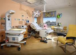 Interior of a Labor Room with medical equipment and birthing bed