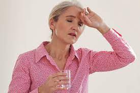 Woman staying hydrated with a glass of water
