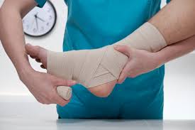 Sprains: Healthcare Professional Applying Bandage to Sprained Foot for Support