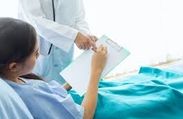 Woman signing a document in the labor room