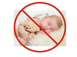 Sleeping baby with stuffed toy under 'Do Not' sign - Sudden Infant Death Syndrome (SIDS) risk