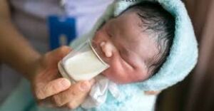 how mother can feed baby: Baby being fed from a cup