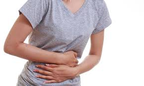 Person experiencing abdominal pain while leaning forward