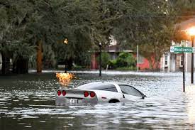 Car Partially Submerged in River: Vehicle Caught in Floodwaters