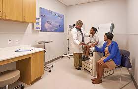  ER visit - Doctor providing medical care to a male child while their mother looks on