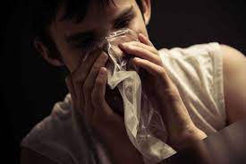 Person inhaling a substance through a clear bag