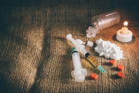 Syringes and crystals displayed on a surface: substance abuse