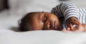 A baby sleeping soundly, peacefully resting in a cozy environment.