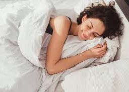 Image of a person resting in bed, promoting relaxation and well-being. Quality rest is essential for overall health and happiness