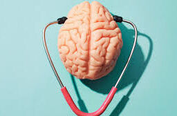 Neurological Care: An image displaying a stethoscope alongside a detailed illustration of a brain, emphasizing the connection between healthcare and brain health in commemoration of brain injury awareness month