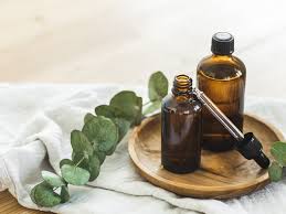 A selection of natural remedies, including herbal teas, essential oils, and tinctures, arranged on a wooden table.