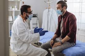 Male patient discussing men's health with doctor during medical consultation