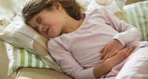 Child holding abdomen in pain