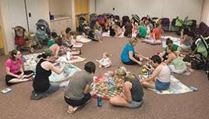 A circle of mothers in a postpartum support group, sharing stories and supporting each other’s well-being.