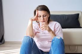 Woman contemplating drinking water for menopause symptoms relief