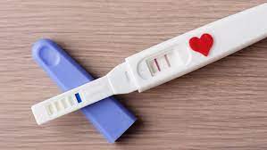 An image of a pregnancy test showing a clear false positive result, with two lines visible on the test strip. The test is placed on a neutral surface, and the faintness of one line or accompanying context suggests the result is inaccurate.