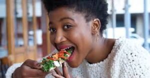 Picture capturing the essence of eating on time with a person enjoying a meal.