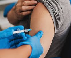 Image Alt Text: Person receiving a tetanus shot on the arm for protection against lockjaw.