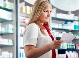 Prescription safety: Pharmacy staff confirming details to prevent errors.