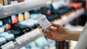 A person examines a medications bottle