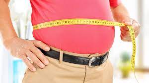 Tea Health Benefits: Man measuring waist size, tracking progress on the path to better health and weight management.