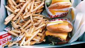 Platter of burgers and fries - indulgence in eating fat