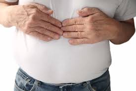 Person holding abdomen due to gas pain