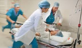 A person being rushed into the emergency room on a stretcher, highlighting the urgency of seeking immediate medical attention for potential heart attack problem.