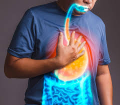 Person clutching chest in discomfort due to heartburn