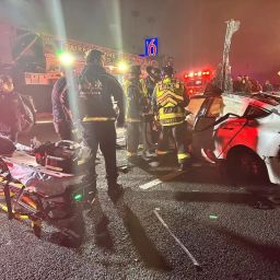 Car accident with emergency personnel: First responders attend to a scene, ensuring swift aid and safety measures.