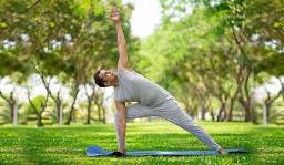 Man practicing yoga outdoors, promoting physical and mental well-being for men's health