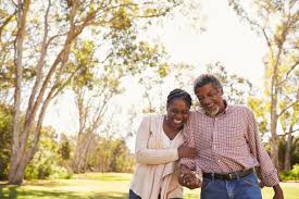 A couple enjoying a daily walk in the serene beauty of the park.