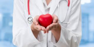 Healthcare professional holding a red heart-shaped object