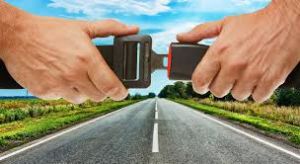 Person buckling up seat belt: Ensure your safety with proper seat belt use.