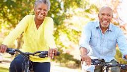 Couple enjoying a bike ride through the park to manage chronic diseases