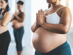 Pregnant woman meditating - An image depicting a serene pregnant woman practicing meditation, a beneficial practice for relaxation and stress reduction during pregnancy.