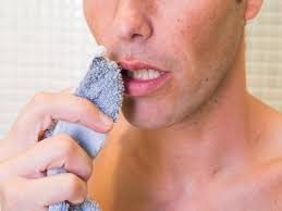 Person applying ice to the lip