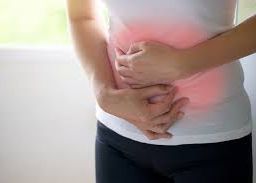constipation: Person clutching their stomach in discomfort