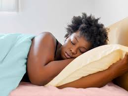 Woman Asleep Comfortably with a Pillow Under Her Head - Achieving restful sleep despite a persistent cough with proper elevation.