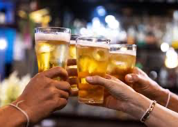A group of people toasting with their glasses of beer
