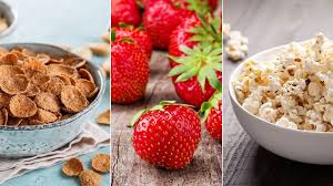 relieving constipation: Bowl of cereal, popcorn and fresh strawberries
