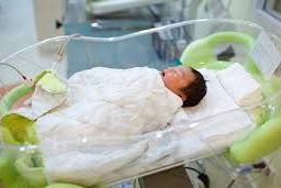 Serene nursery scene: A baby peacefully asleep in a cot, highlighting the importance of a warm and nurturing sleep environment for your little one's comfort and well-being.
