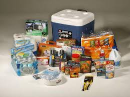 Assorted non-perishable food items displayed near a cooler 
