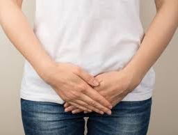 Person experiencing discomfort in the perineal region - a potential symptom of yeast infection.