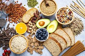 Assorted fiber-rich foods including fruits, ideal for managing constipation vegetables, whole grains, nuts, and seeds