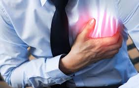 A man in distress, clutching his chest in evident pain