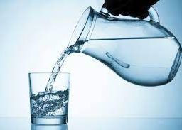 Refreshing moment captured: A jug of water being poured into a glass, highlighting the simple pleasure and necessity of staying hydrated.
