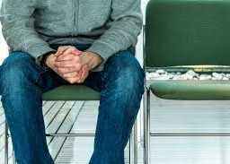 Man seated in waiting area