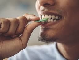 Person enjoying a snack with a smile