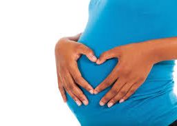 Pregnant woman embracing a healthy diet while joyfully bonding with her baby, promoting wellness for both mother and child.